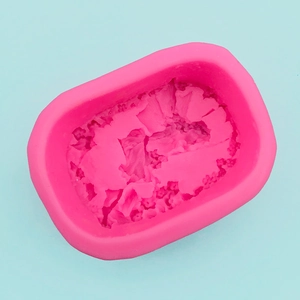 Macro detail of flexible rose pink silicone mold with intricate floral texture for DIY soap