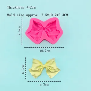 Pink bow-shaped silicone mold for cake decorating with detailed lattice pattern bow