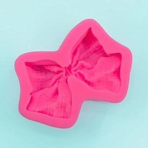 Macro detail of pink bow silicone mold with fabric texture for DIY fondant cake decor