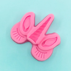 Detailed pink silicone mold featuring unicorn horns, ears and eyelashes for fondant DIY