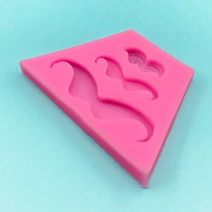 Pink silicone mold featuring three mustache shapes for fondant and cake decorating