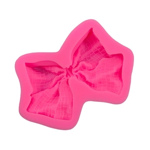 Pink silicone bow mold for fondant and cake decorating with fine grid texture
