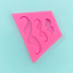 Macro view of pink silicone mold with three mustache shapes for DIY cake baking and crafts