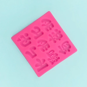 Macro view of pink silicone mold featuring Chinese good luck character engravings