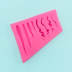 Detail of pink silicone mold with 8 wave texture patterns for fondant cake decoration
