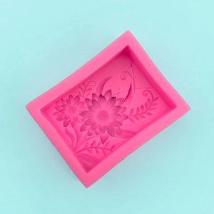 Detailed macro view of rectangular pink silicone mold with flower and leaf textures