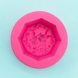 Detail view of pink silicone mold with 3D octagonal cavity and cat floral textures