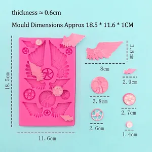 Pink silicone mold with gear and wing shapes for DIY chocolate and cake decoration