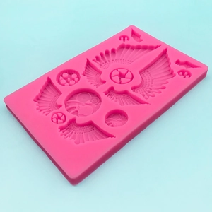 Pink silicone mold with wing and emblem patterns for DIY fondant cake decoration