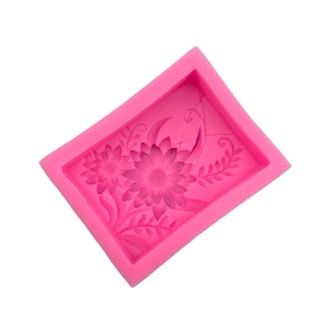 Pink rectangular silicone mold with intricate sunflower patterns for soap and fondant cakes