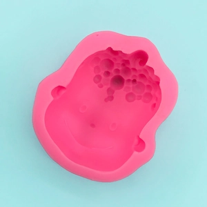 Close-up of pink silicone 3D baby boy face mold for fondant and DIY soap crafts