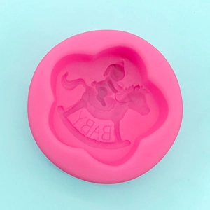 Macro detail of a pink silicone mold featuring a baby rocking horse and Baby text design