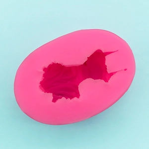 Macro shot of pink silicone Pomeranian mold featuring detailed textured fur for 3D baking