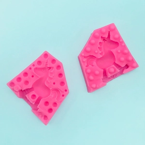 Detailed close-up of pink silicone unicorn mold for chocolate and handmade soap making