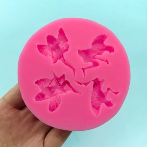 Pink silicone mold featuring four fairy angel wings for fondant cake decorating and DIY art
