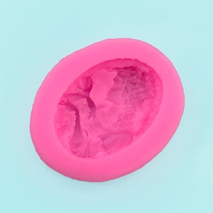 Detailed top view of a pink silicone mold with an intricate European relief portrait
