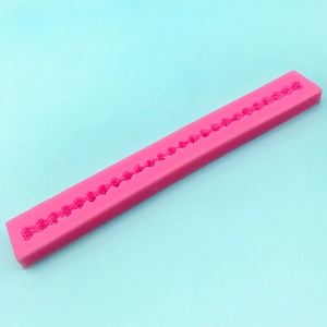 Pink silicone long strip mold with floral patterns for DIY cake borders and baking decor