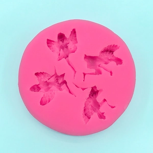 Pink silicone mold featuring four detailed cartoon character shapes for cake decorating