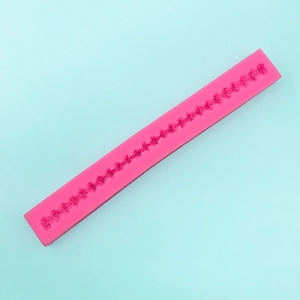 Detail of pink silicone lace mold with floral patterns for fondant cake decoration