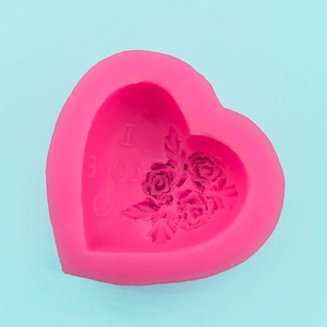 Macro detail of a heart-shaped silicone mold with rose pattern and I LOVE U engraving