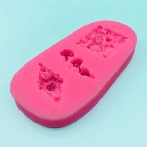 Pink silicone mold for fondant cake borders with three 3D floral lace patterns