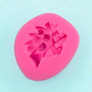 Detailed macro view of flexible pink silicone mold featuring a cartoon head silhouette design