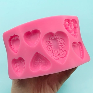 Pink heart-shaped silicone mold with floral patterns for DIY handmade soap and chocolate crafts