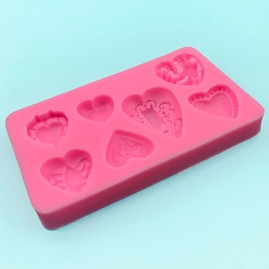 Pink heart-shaped silicone mold with 7 unique decorative patterns for DIY chocolate crafts