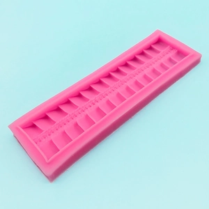 Pink rectangular silicone lace mold with geometric zipper texture for fondant cake borders