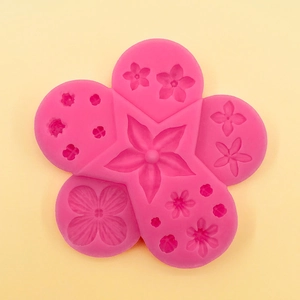 Detail view of pink silicone mold with multiple flower shapes for cake decorating and DIY