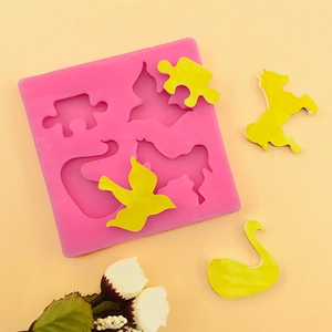 Pink silicone mold for DIY crafts featuring animal shapes like swan, horse and birds