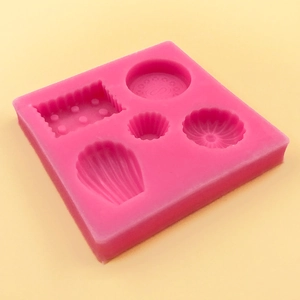 Fuchsia silicone mold with shell and biscuit shapes for DIY fondant and wax seal making
