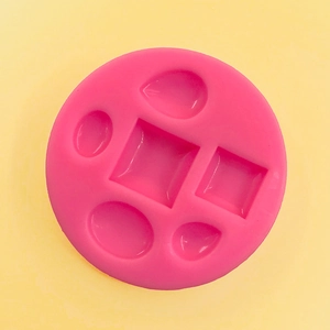 Pink silicone mold with geometric square, drop, and oval cavities for DIY jewelry crafts