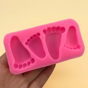 Pink silicone mold featuring baby footprint shapes for DIY cake baking and chocolate crafts