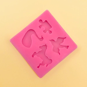 Macro detail of pink silicone mold featuring puzzle, horse, and swan shapes for DIY crafts