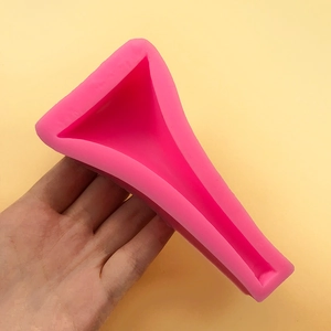 Ergonomic pink silicone female urination device with funnel design held against yellow background