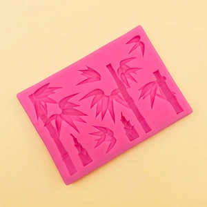 Detail showing pink silicone mold with intricate bamboo leaf and stalk patterns for cakes