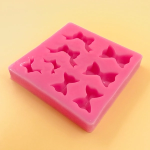 Pink silicone mold featuring 8 distinct bow shapes for cake decorating and DIY chocolate