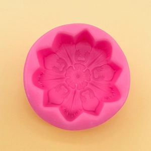 Macro shot of pink silicone flower mold featuring intricate mandala patterns and petal details