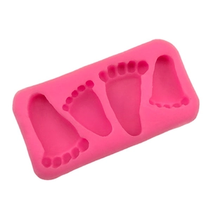 Pink silicone mold featuring four baby footprint shapes for DIY cake baking and crafts
