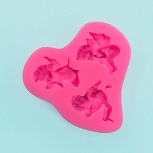 Macro detail of three-cavity heart-shaped pink silicone mold for fish-themed fondants