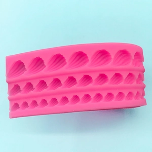 Pink silicone cake mold with triple-layered decorative shell border pattern