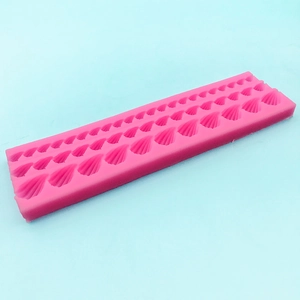 Pink silicone fondant mold with scallop shell patterns for DIY cake decorating and baking