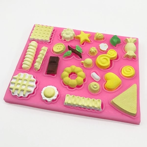 Pink silicone mold for DIY sweets featuring waffle, chocolate and donut shapes