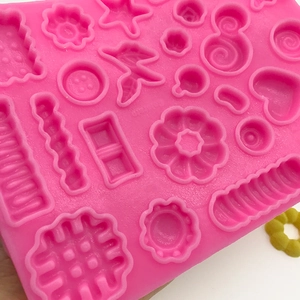Pink silicone mold featuring flower and heart shapes for DIY candy and fondant cake decor