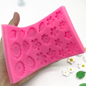 Pink silicone mold featuring sunflower and daisy shapes for DIY fondant cake decorations