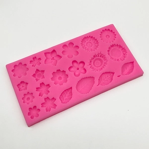 Detail view of pink silicone mold with flower and leaf shapes for DIY fondant and wax