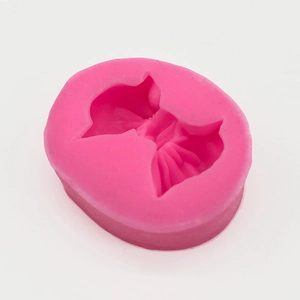 Macro detail of a pink silicone mold featuring a 3D princess dress design for DIY crafts