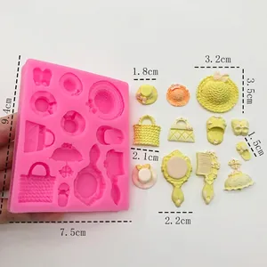 Pink silicone mold for cake decor featuring hat, bag, mirror, and comb shapes