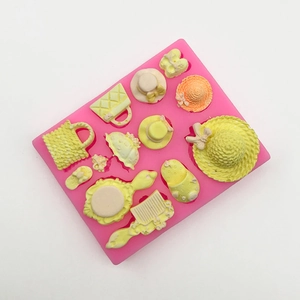 Pink silicone mold for fondant featuring lady hats, handbags, sandals and umbrella shapes